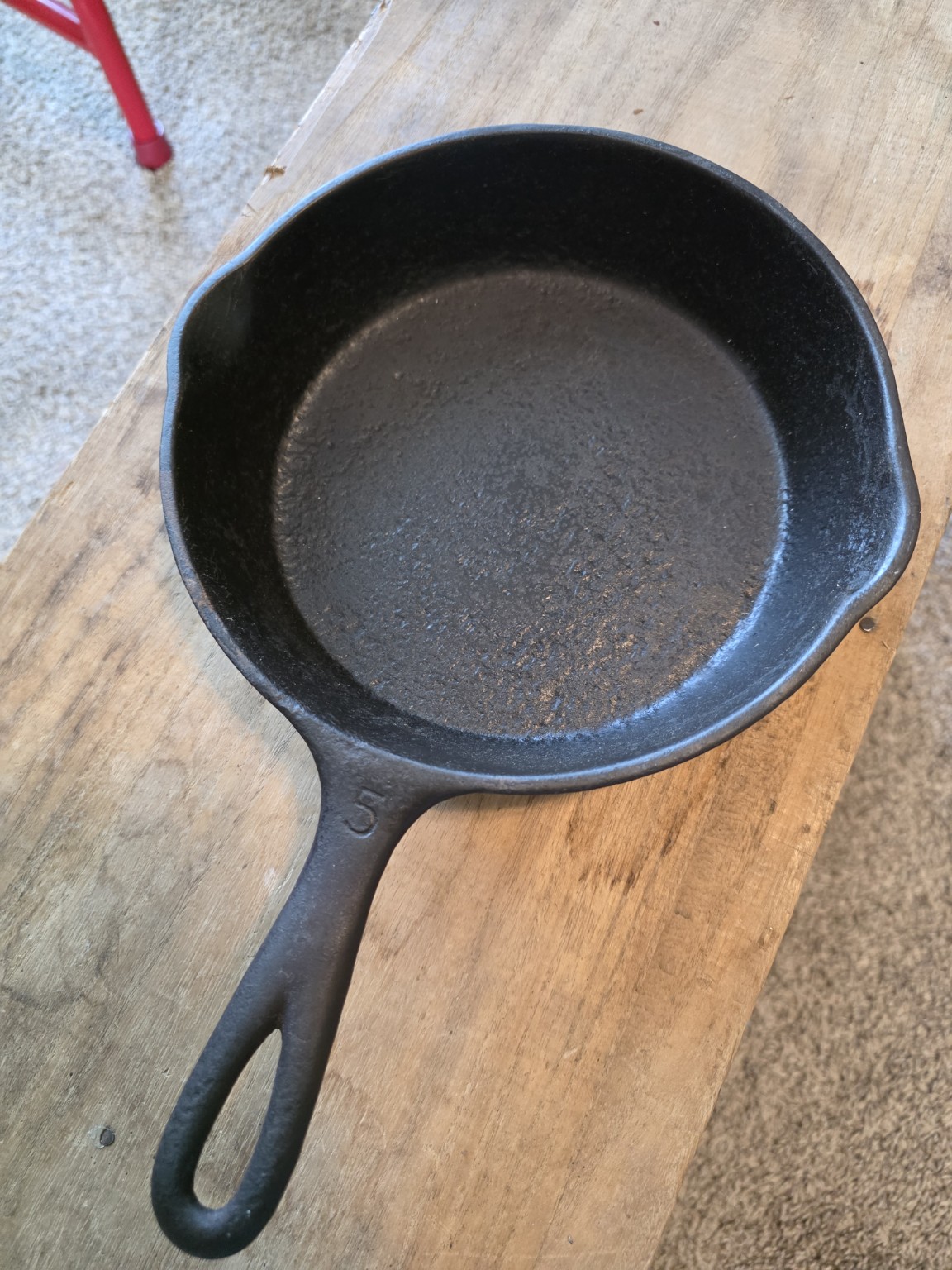 Pitted cooking surface of an early unmarked No. 5 cast-iron skillet