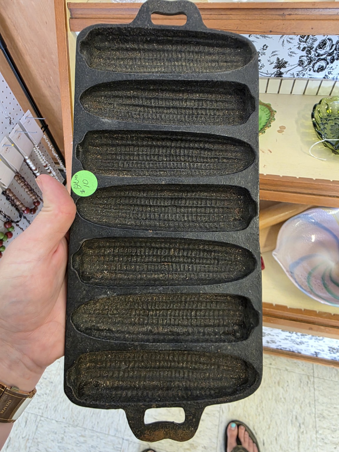 Seven narrow wells of a Birmingham Stove and Range cast-iron corn pan